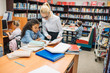 © LIGHTFIELD STUDIOS - teacher with kids in library