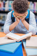 © LIGHTFIELD STUDIOS - schoolboy reading book in library
