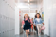 © LIGHTFIELD STUDIOS - pupils running through school corridor