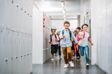 Fototapeta  - pupils running through school corridor