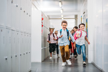 Pupils Running Through School Corridor