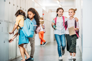 schoolgirls walking through school corridor