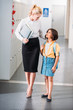 © LIGHTFIELD STUDIOS - teacher and schoolgirl walking together