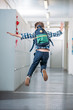 © LIGHTFIELD STUDIOS - boy jumping in school corridor