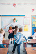 © LIGHTFIELD STUDIOS - teacher embracing with pupils