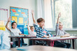 © LIGHTFIELD STUDIOS - kids raising hands in class