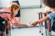 © LIGHTFIELD STUDIOS - schoolgirls passing message in class
