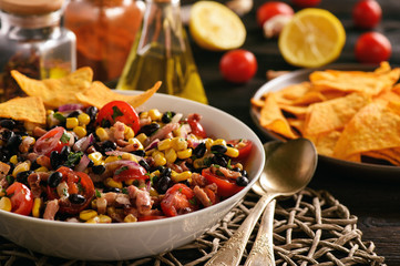 Mexican salad with black bean, corn, tomatoes and chorizo.