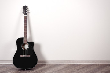 Poster - Black Classical Acoustic Guitar in an Empty Room with Copy Space
