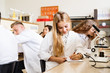 © Halfpoint - High school student with microscopes in laboratory.