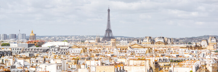 Wall Mural - Aerial panoramic cityscape view on the beautiful buildings and Eiffel tower on the horizon during the cloudy weather in Paris