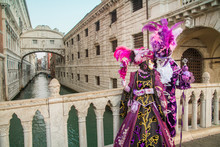 Costumed People At The Bridge Of Sighs During The Carnival Of Venice, Italy