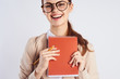 © SHOTPRIME STUDIO - A woman with glasses is holding a notebook