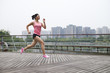 © Bo Bo/Stocksy - young asian woman doing exercise in the park
