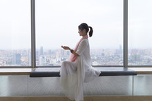 Young Asian Woman Doing Yoga By The Big Window Indoor