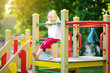 © MNStudio - Cute little girl having fun on a playground outdoors in summer.