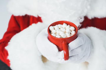 santa drinking hot chocolate with marshmallows