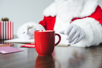 santa drinking hot chocolate with marshmallows