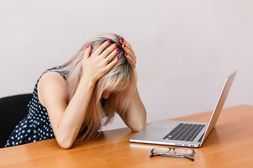 Frustrated and stressed woman at her laptop. Stress concept.