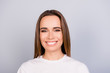 © deagreez - Close up portrait of successful young brown haired lady entrepreneur in white casual t shirt, standing on the pure light grey background, with beaming smile