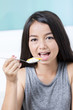 © sirikorn - Casual happy asian girl dieting and eating healthy rice at home