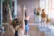 © Somkiat - Women exercising in fitness studio yoga classes