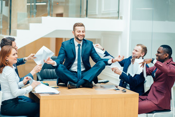 Wall Mural - young handsome business man in black suit practice yoga and relax at office