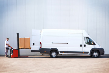 Courier is loading the van with parcels.