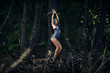 A girl tied to a tree in a forest. Dark forest. Esoterics