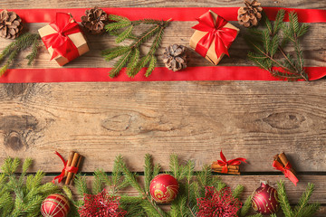 Poster - Frame made of fir tree branches and Christmas decor on wooden background