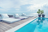 Fototapeta  - The edge Luxury swimming pool with white fashion deckchairs on the beach.