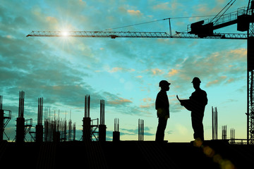 Silhouette images of construction sites are underway and workers are working