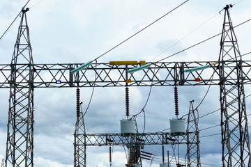 high voltage electricity pylon and circuit breaker with cloudy sky