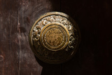 Traditional Bronze Door Handle On A Wooden Door