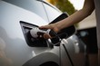 © Wavebreak Media - Woman charging electric car