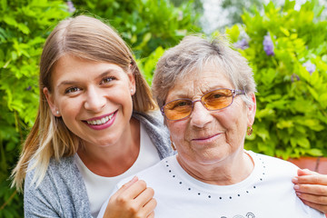 Wall Mural - Senior lady with beautiful granddaughter