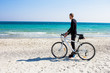 © serejkakovalev - Bicycle rider relaxing on the beach in good weather