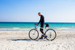 © serejkakovalev - Bicycle rider relaxing on the beach in good weather