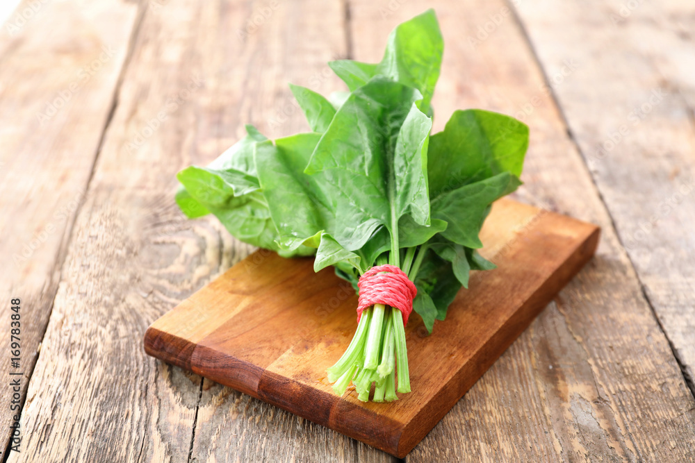 Fresh spinach bunch on wooden board