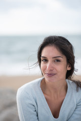 Wall Mural - Portrait of a beautiful young brunette woman on the beach