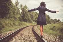 Girl Balancing On The Train Rail 
