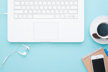 Overhead view of working space with white laptop, mobile device and cup of coffee, Business and online marketing on pastel color background