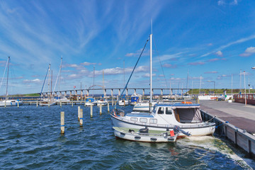 Boats in the Rudkobing harbor with the Langelandsbroen on the island Langeland, Denmark