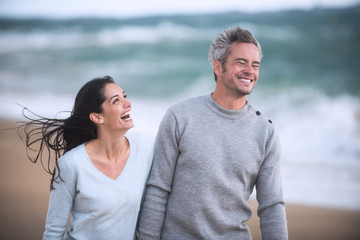 Wall Mural - Portrait of a couple walking on the beach