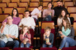 © JackF - A group of people eating popcorn and watching a movie
