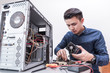 The technician put the CPU cooling fan on the computer mainboard. the concept of computer hardware, repairing, upgrade and technology.