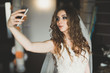 © olegparylyak - Beautiful bride making selfie in the home before wedding