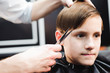 © nagaets - cute young boy getting a haircut