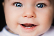 Baby Portrait. Closeup Face With Bright Blue Eyes