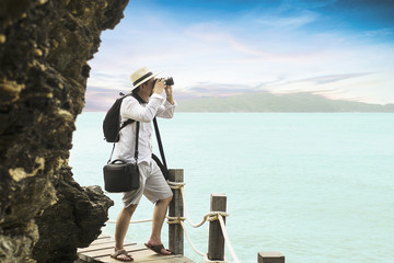 Man taking seascape photo 